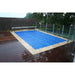 Blue solar bubble cover fitted across an outdoor swimming pool