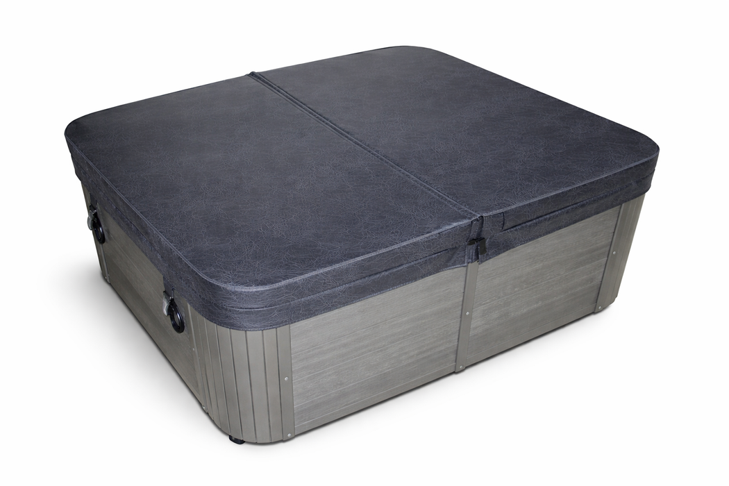 Charcoal grey square spa pool cover shown at an angled front view with tapered insulated design and fitted skirt panels.