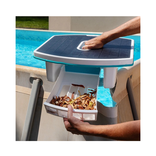 Solar powered pool surface skimmer cleaner collecting leaves and debris in an above ground pool