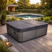 Charcoal spa cover fitted to an outdoor spa on a timber deck beside a swimming pool