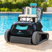 Dolphin Liberty 200 pool cleaner with the lid open and filter basket raised beside a swimming pool.