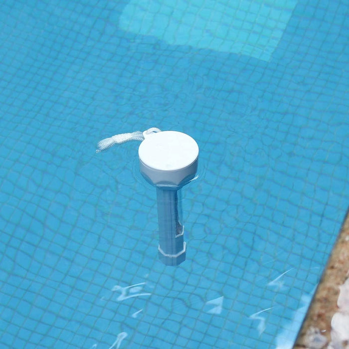 Jumbo floating pool thermometer tethered at the edge of a swimming pool