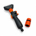 Black and orange filter cleaning wand beside its separate orange hose connector, showing the spray head and handle controls.