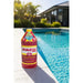 Scaletec Plus pool descaler and stain remover bottle beside a swimming pool