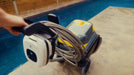 Zodiac CX-series robotic pool cleaner on its caddy with coiled cable