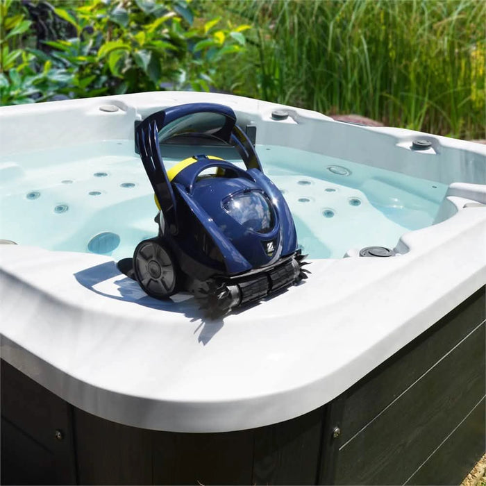 Zodiac Spabot cordless robotic spa cleaner resting on a spa pool edge in an outdoor setting